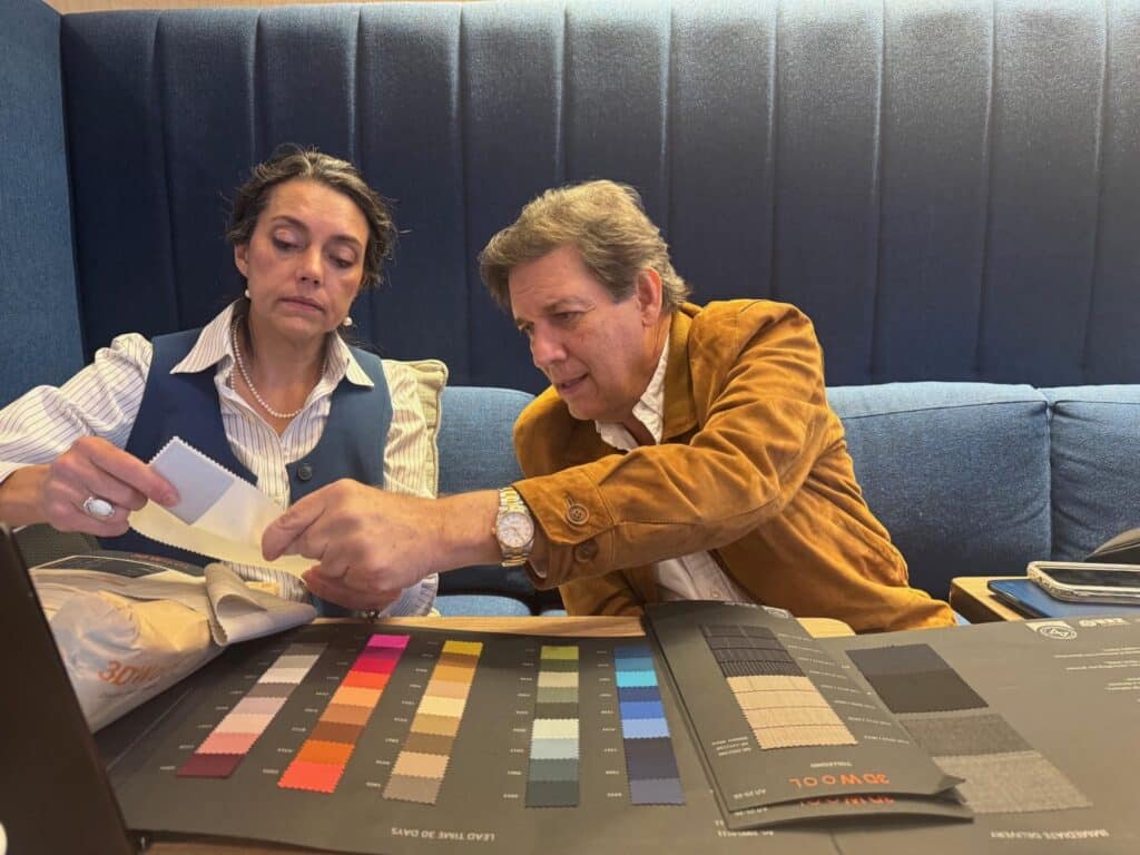 Nena Cavalieri reviewing fabric samples with designer
